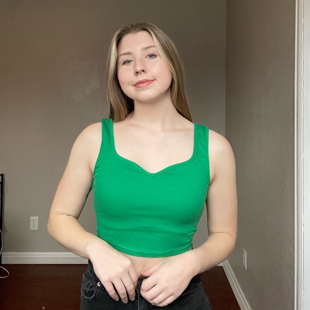 True green colored crop tank top with a unique neckline.
